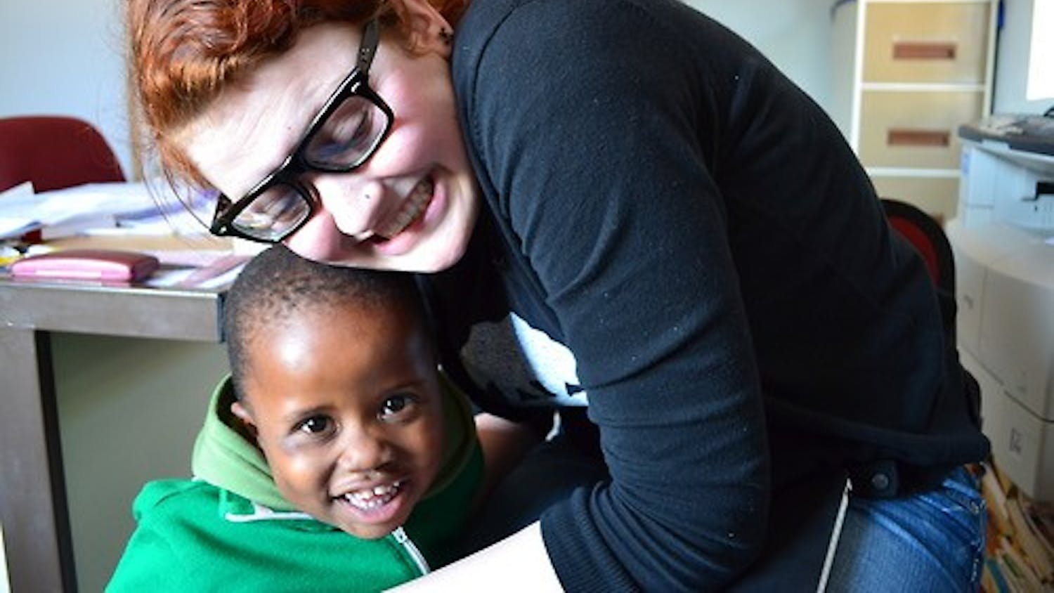 Rising College junior Rosa Escandon hugs a student at Kamogelo Orphanage in Botswana. Escandon and another IIP intern are trying to raise $25,000 for Kamogelo by the end of August.