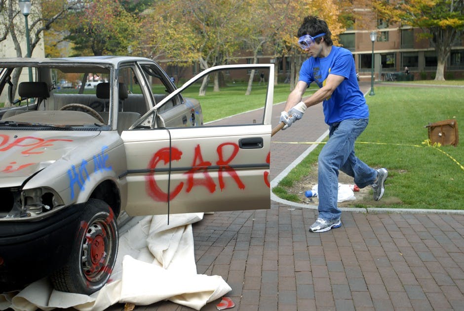 Students smash a Toyota Corolla for charity at ZBT fundraiser