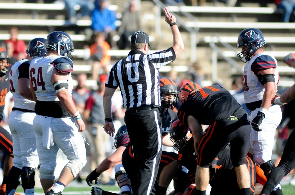 On the Quakers' last drive, Alec Torgersen fumbles the ball and the referee signals a turnover.