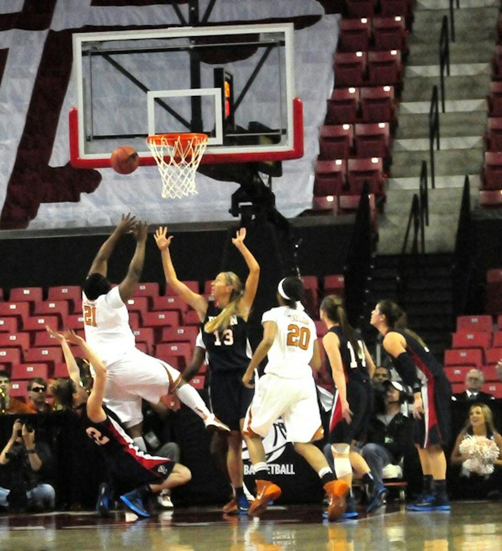 Texas freshman Nekia Jones converted an important basket in the second half, making a layup while being fouled by Penn junior forward Kara Bonenberger(left), who picked up her fifth and disqualifying foul on the play.