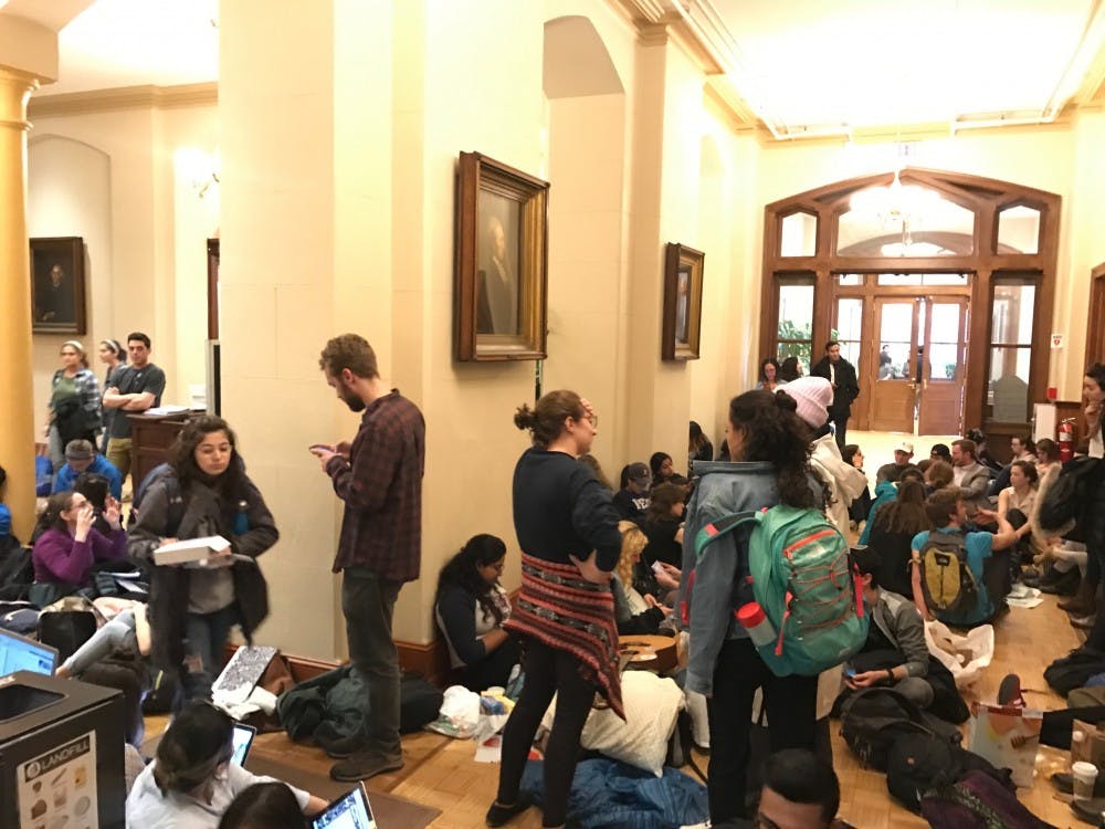 Protesters congregate near the entrance to College Hall on the last day of Fossil Free Penn's four-day sit-in.&nbsp;