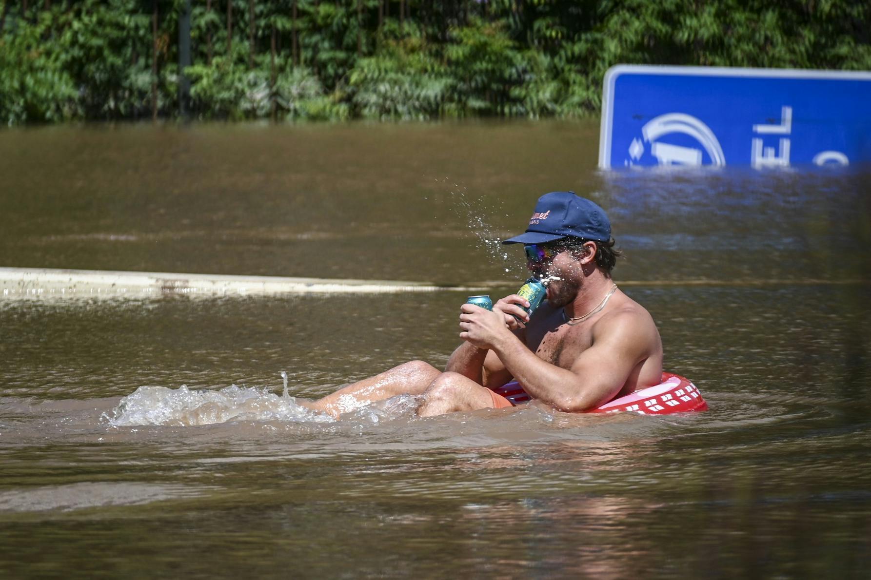 09-02-21 Hurricane Ida Flooding Floatie Swimming Beer (Kylie Cooper).jpg