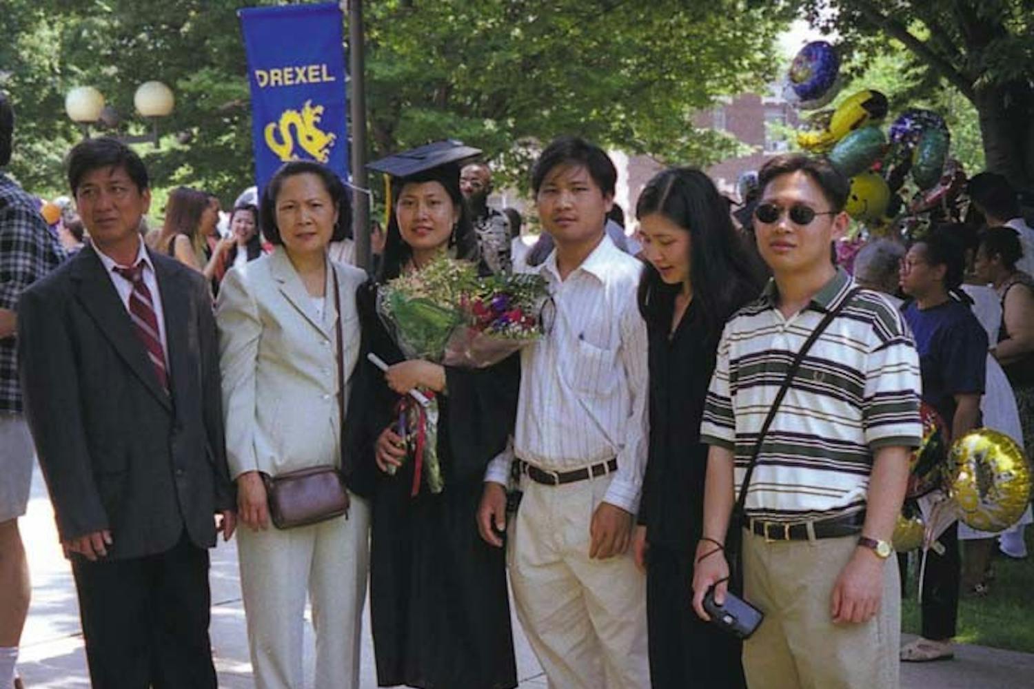 Don Ly (far left) stands with his family at his oldest daughter’s college graduation.