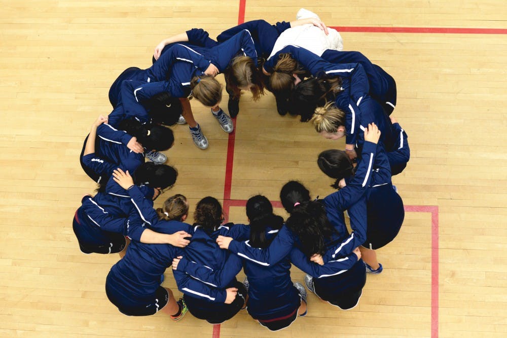 No. 2 Penn women's squash huddles during their weekend sweep of Rochester and Williams.