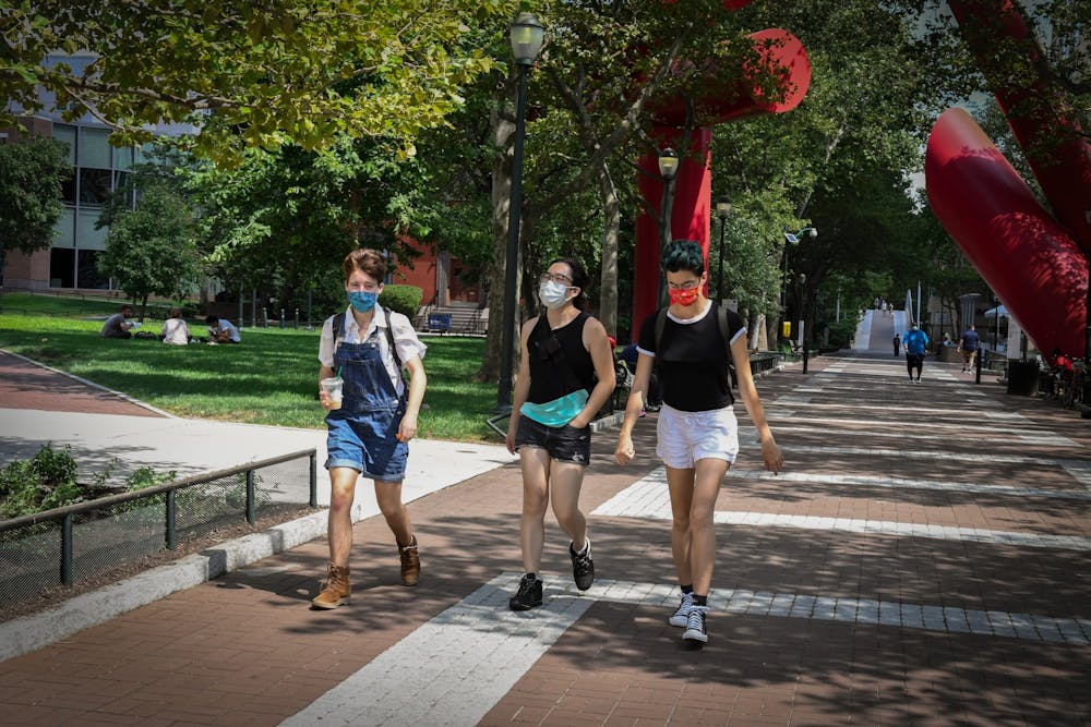 coronavirus-campus-people-in-mask-walk-tampons