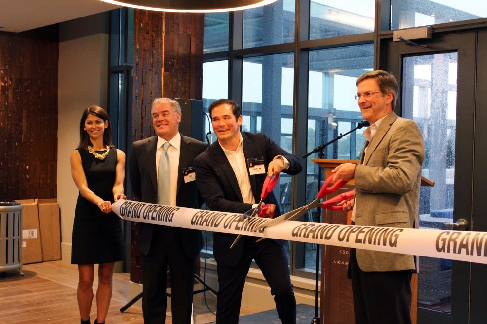 Tim and Dustin Downey, developers of University City's new apartment complex at 3601 Market, helped cut the ribbon at the grand opening of the building.