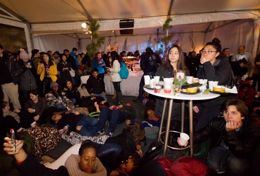 Protesters at President Amy Gutmann's holiday party participate in die-in as College junior Gina Dukes — not pictured — spoke about Ferguson, Eric Garner and the Laporshia Massey, a seventh grader who died of an asthma attack in a Philadelphia public school that had no school nurse on duty.