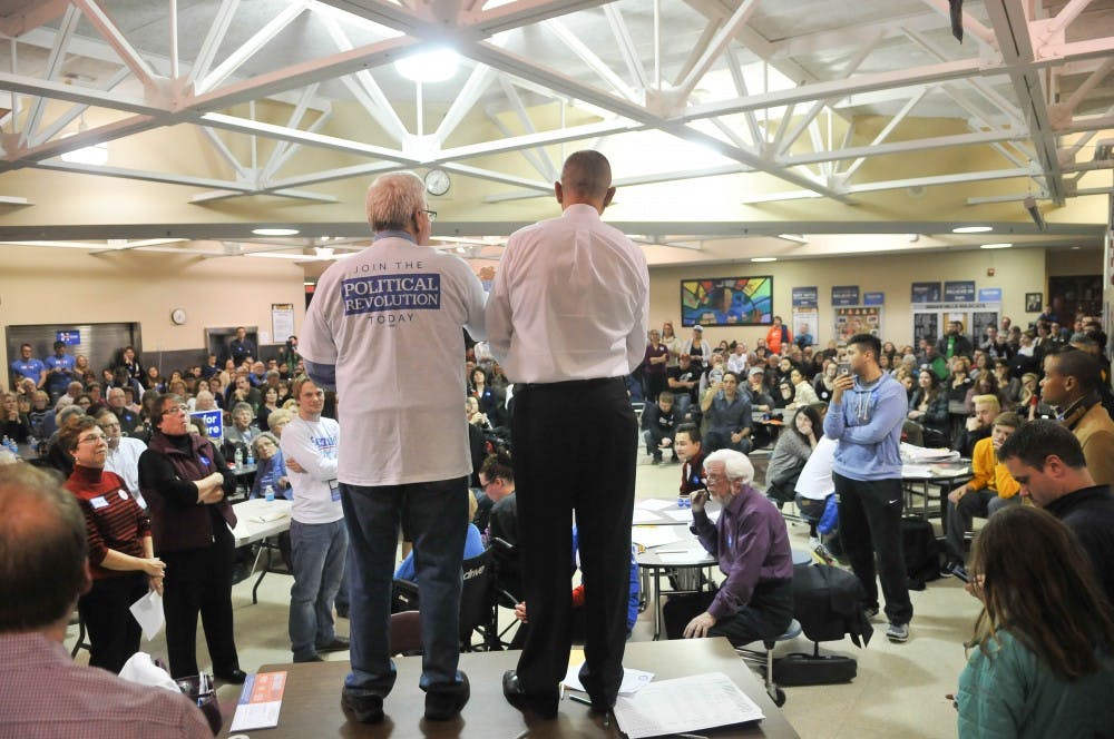 A supporter for Bernie Sanders speaks to the room in an attempt to sway the undecided caucus-goers to support Sanders.