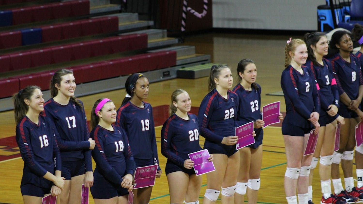 Before Saturday's game, players, coaches and fans held up signs with the names of people close to them who have battled or are battling breast cancer.