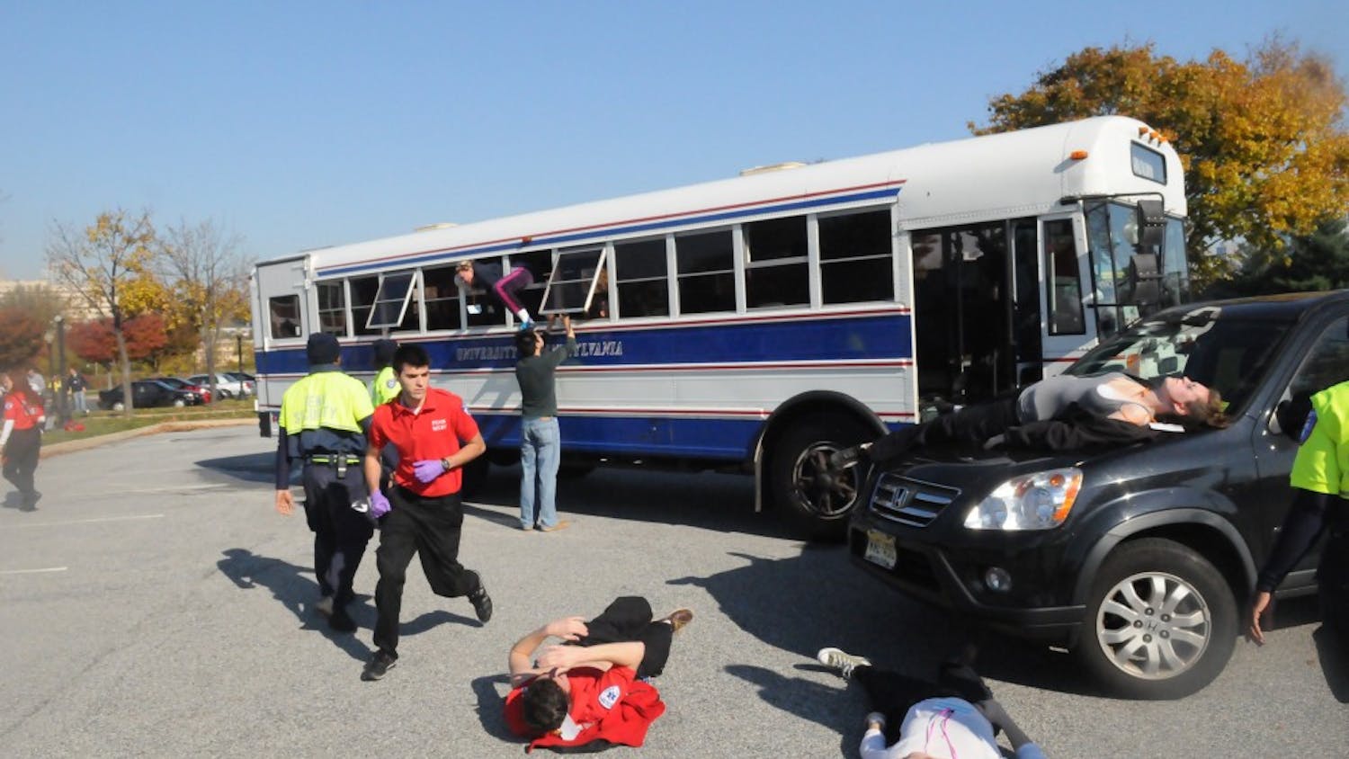 MERT members respond to simulated mass casualty incident of a car and bus collision. The injured wore makeup and fake lacerations to make the simulation more realistic.
