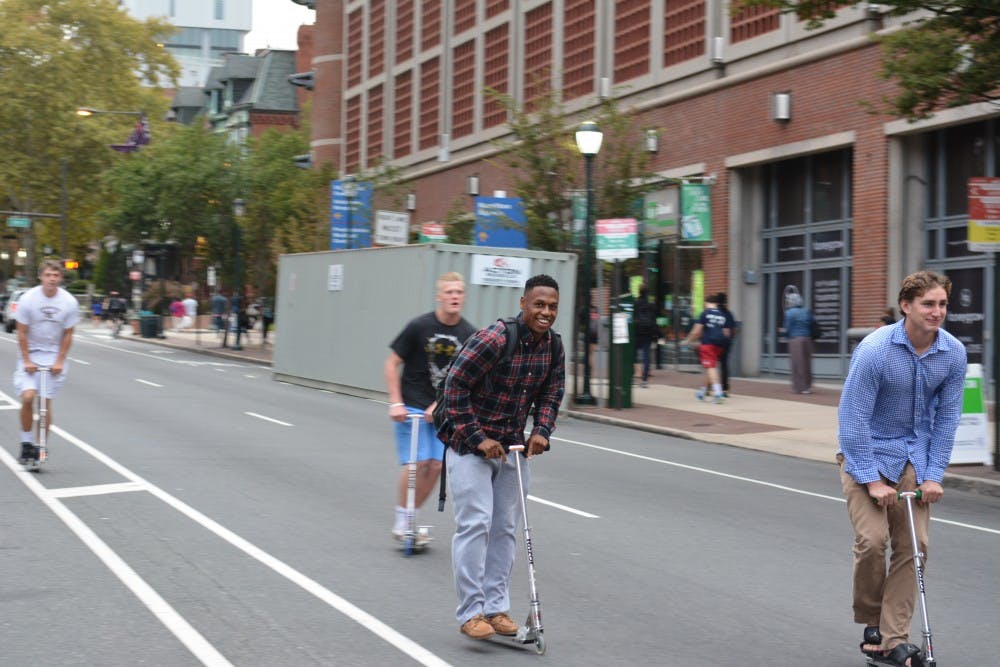 Students rode scooters down a vacant Walnut Street.