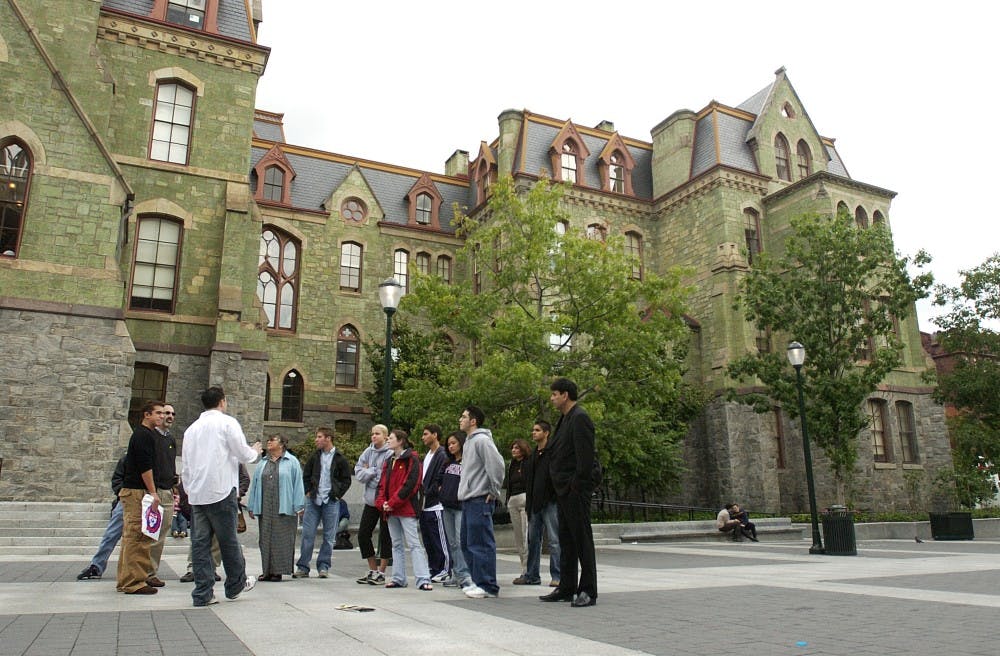 Tour guide Jonathan Kahn (seas 04) shows prospective  students and penn students the perelman quadrangle
 File Name : DSC_0071.NEF
 File Size : 2.0MB (2149126 bytes)
 Date Taken : Thu, Oct 2, 2003 10:54:24 AM
 Image Size : 2000 x 1312 pixels
 Resolution : 300 x 300 dpi
 Bit Depth : 12 bits/channel
 Protection Attribute : Off
 Camera ID : N/A
 Camera : NIKON D1H
 Quality Mode : HI (2.7M Raw Compressed)
 Metering Mode : Center-Weighted
 Exposure Mode : Manual
 Speed Light : No
 Focal Length : 17.0 mm
 Shutter Speed : 1/3200 seconds
 Aperture : F2.8
 Exposure Compensation : 0.0 EV
 White Balance : Cloudy
 Lens : 17-35 mm F2.8
 Flash Sync Mode : N/A
 Exposure Difference : -0.1 EV
 Flexible Program : No
 Sensitivity : ISO800
 Sharpening : Normal
 Image Type : Color
 Color Mode : Mode II (Adobe RGB)
 Hue Adjustment : 3
 Saturation Control : N/A
 Tone Compensation : Normal
 Latitude(GPS) : N/A
 Longitude(GPS) : N/A
 Altitude(GPS) : N/A