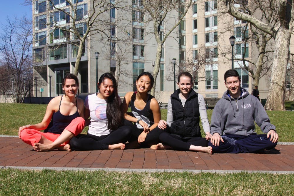 (Left to right) College sophomores Corey Loftus and Karen Zhao, College freshman April Chen, and Wharton juniors Makena Finger, and Wharton junior Tai Bendit-Shtull make up the Be Here team, teaching yoga and meditation to a growing community on campus.
