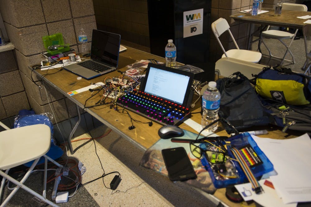 A student’s workspace is filled with computers, snacks and papers alike.