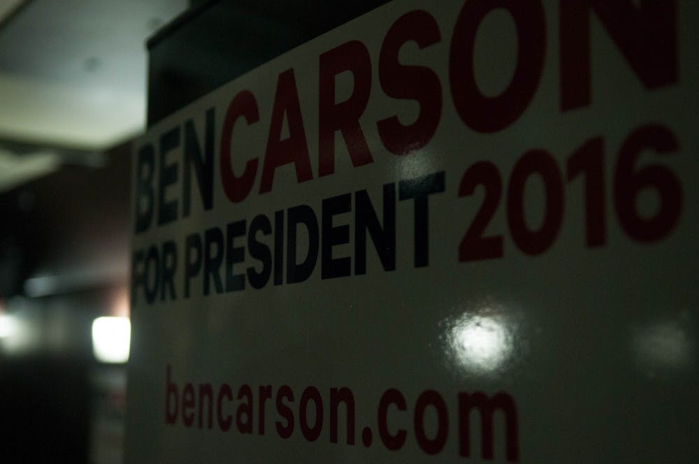 Despite his recent drop in the polls, Carson keeps the inside of his campaign bus optimistically decorated with campaign posters reading 