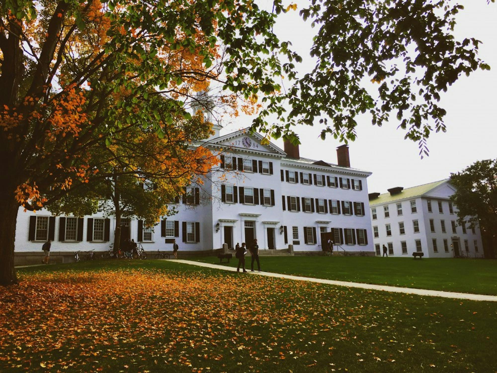 Dartmouth Hall is surrounded by fall leaves.