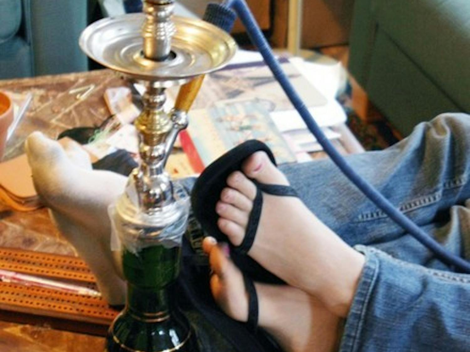 Students above enjoy a hookah, joining a rapidly growing population of Dartmouth students and Upper Valley residents who have made smoking sheesha more popular recently.