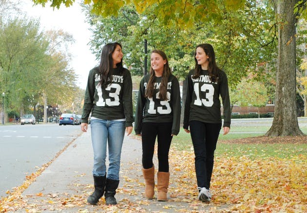 Chloe Gettinger '13, Whitney Bren '13 and Sophie Palitz '13 walk along the Green in their class shirts.