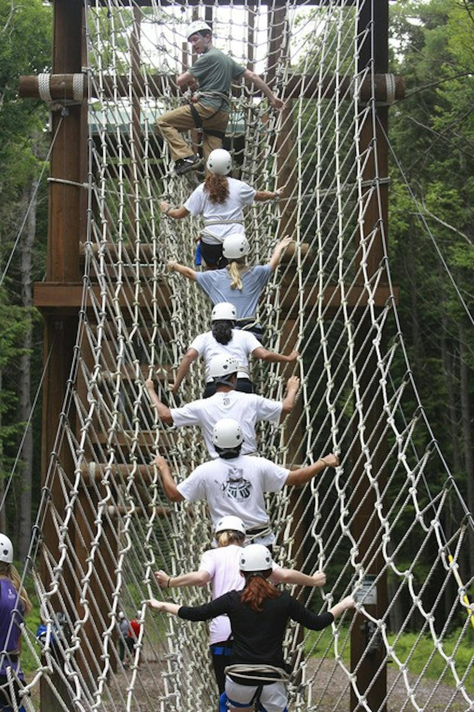 Eight student-athletes of Dartmouth's Leadership Education and Development program spend time at the ropes course. 