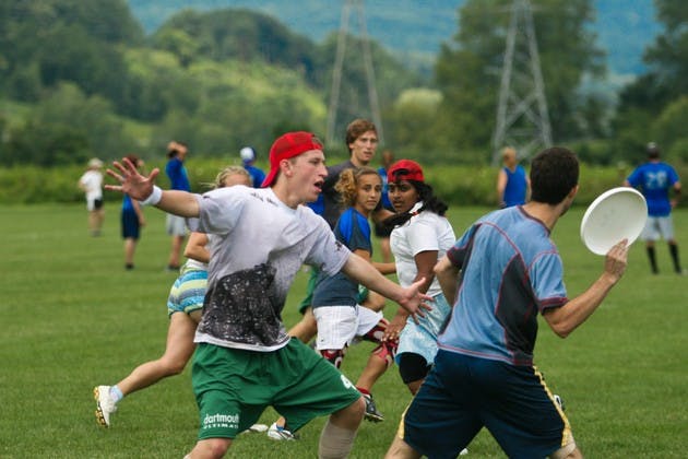 Lars Osterberg '11 and Lakshmi Srinivasan '11, in white, defend against Dartmouth's alumni club team, in blue.