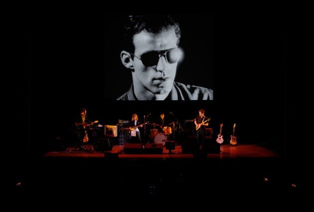 Dean & Britta play in front of a screen test featuring Lou Reed in 