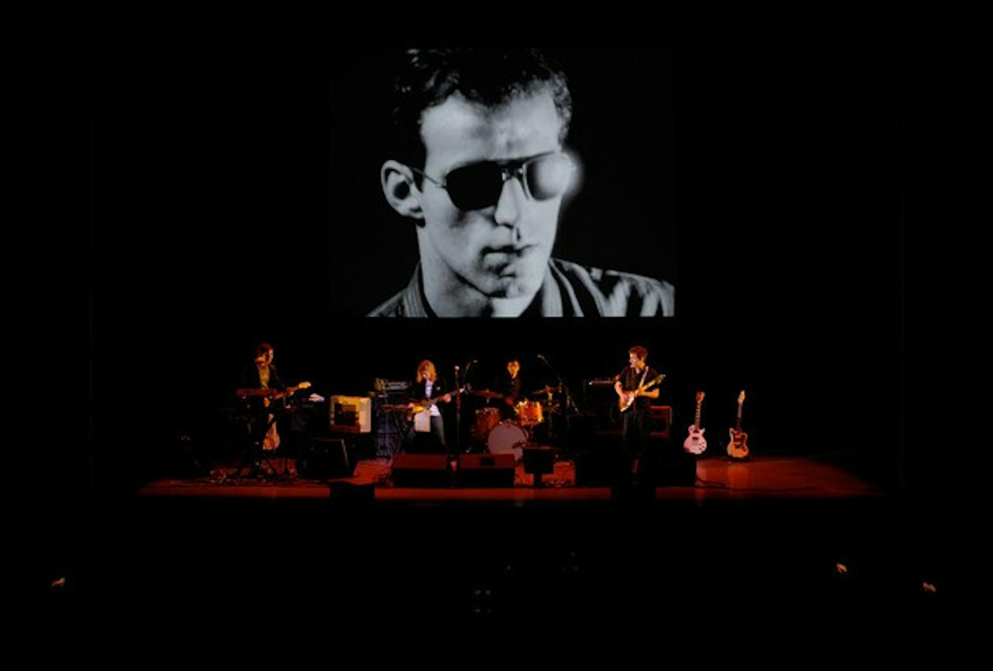 Dean & Britta play in front of a screen test featuring Lou Reed in 