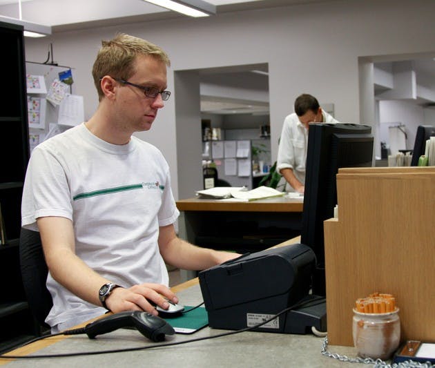 Will McMahan '08 fulfills a work-study requirement at the circulation desk in Berry Library. Dartmouth has not reviewed its financial aid in four years.