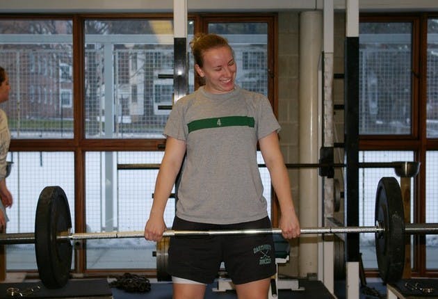 Meredith Batcheller '07, a defenseman on the women's hockey team, lifts weights at a winter workout.