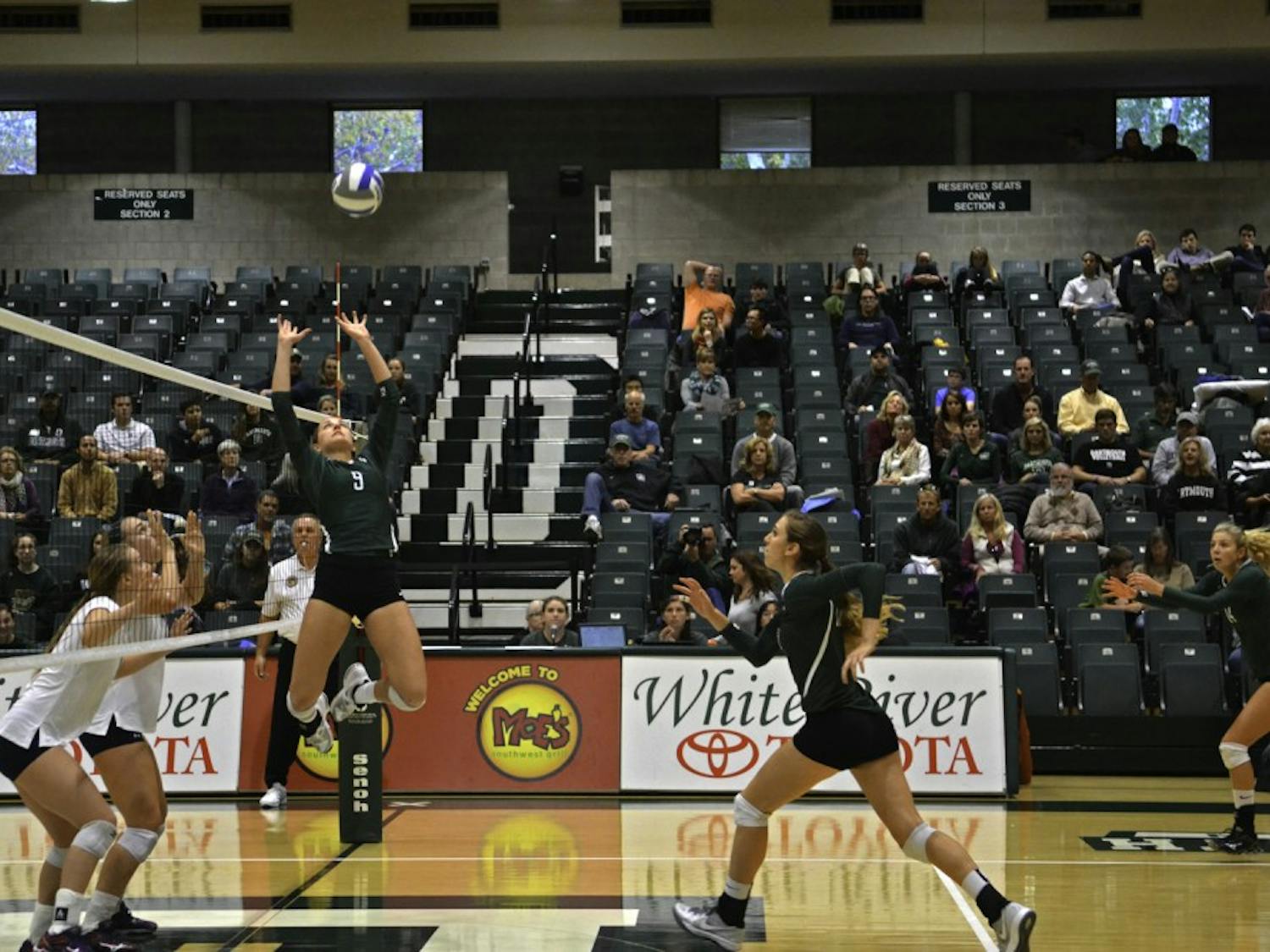 Kayden Cook ’15 leaps high in the air for the set at Leede Arena. Cook had 32 assists in the weekend’s two games.