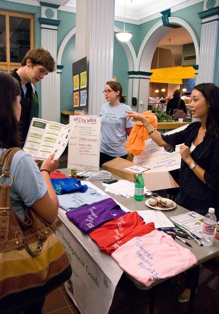Members of the Dartmouth Coalition for Global Health talk to students in Thayer Dining Hall to raise awareness of global poverty.