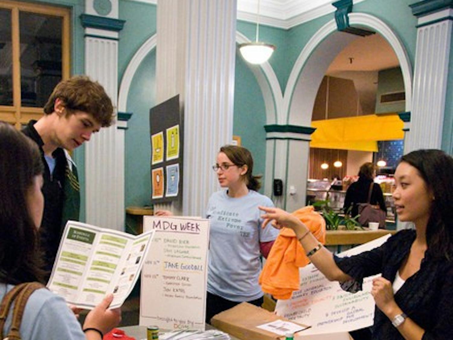 Members of the Dartmouth Coalition for Global Health talk to students in Thayer Dining Hall to raise awareness of global poverty.