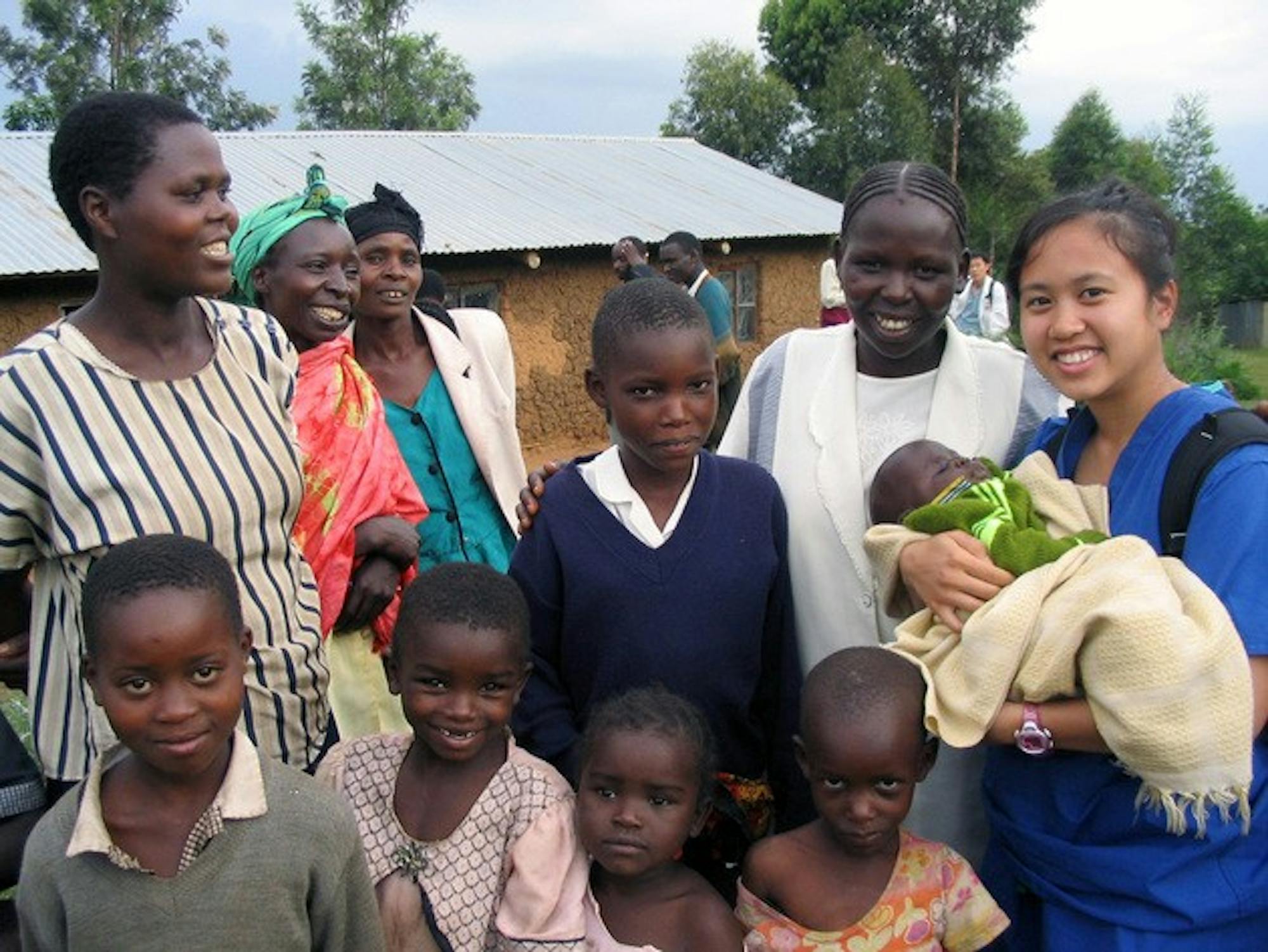 Dartmouth Medical School student Leslie Claracay holds a child in the rural village of Tuikut, in Kenya. So far, the volunteers have raised $13,000 for the health clinic through a letter-writing campaign.