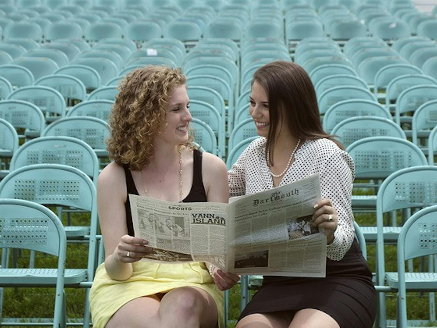 Emma Fidel '12 and Alina Everett '12, editor-in-chief and publisher emerita, read a copy of The D one last time before Commencement.