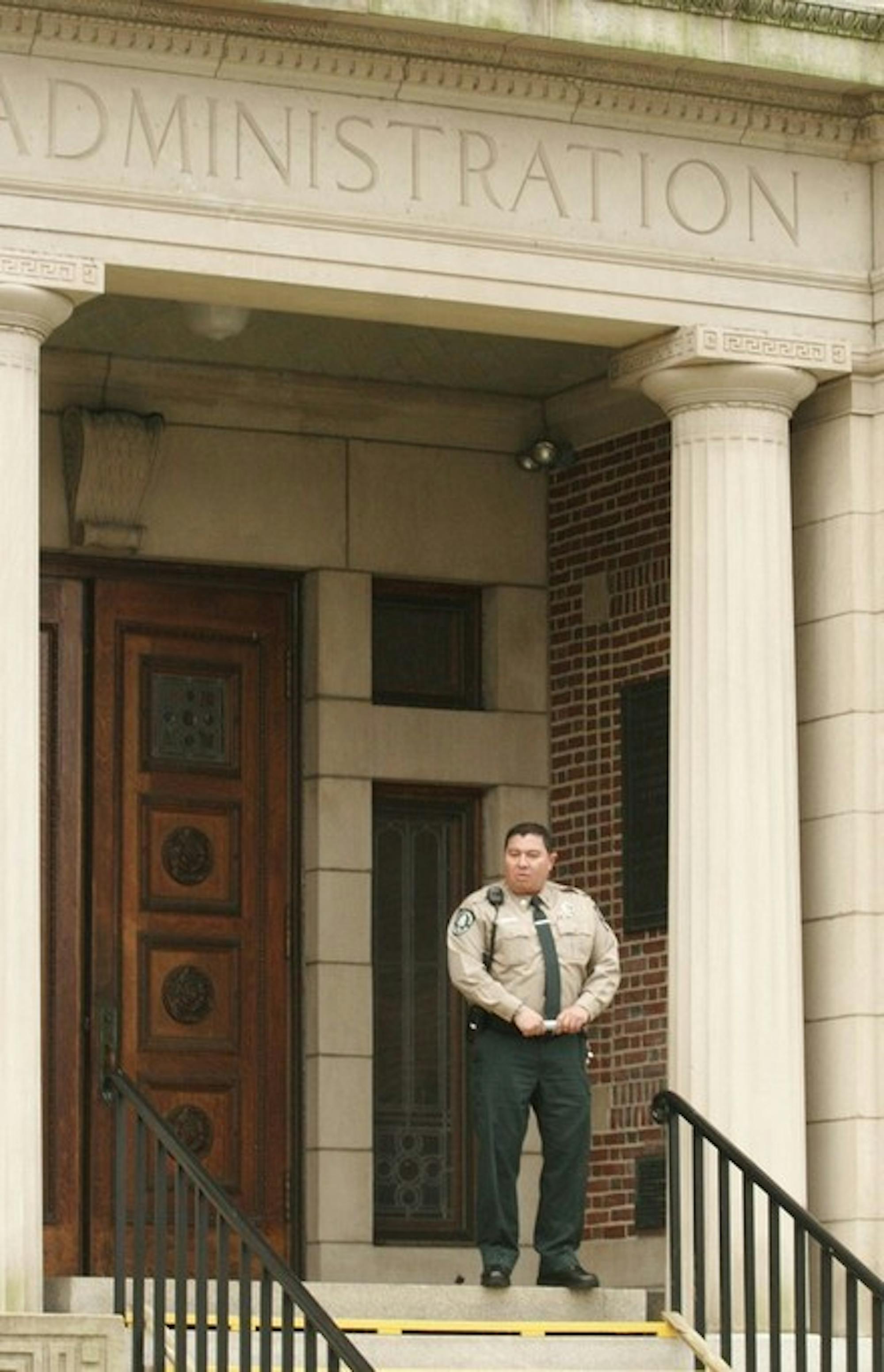 A Safety and Security officer waits in front of Parkhurst Hall on Wednesday afternoon while scores of students rallied at nearby Dartmouth Hall in an event named 