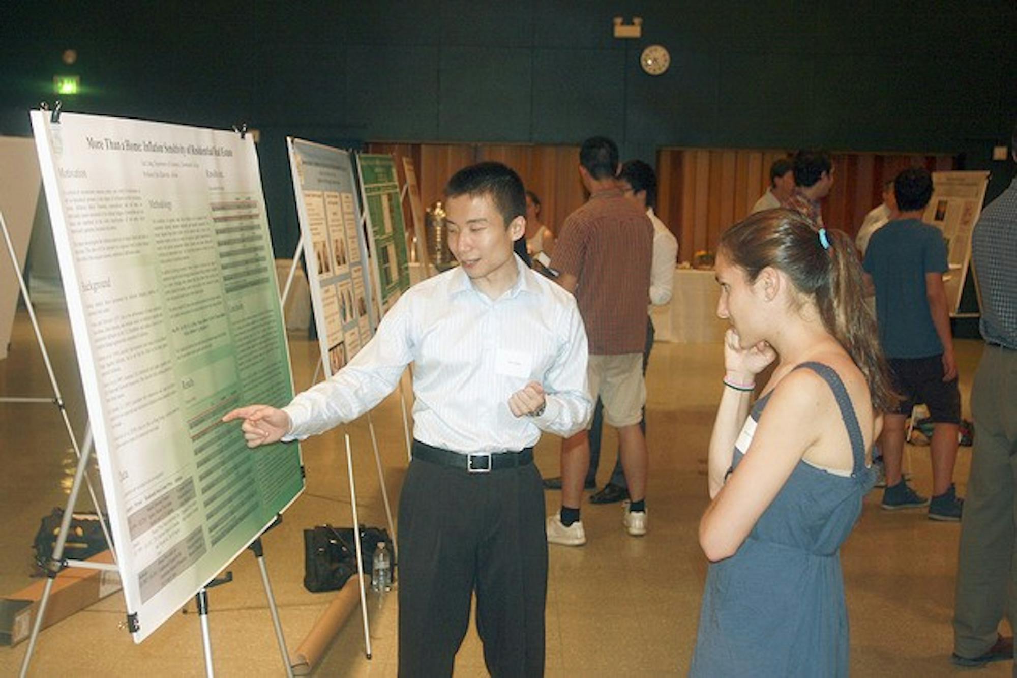 A student presents his thesis work in Alumni Hall.