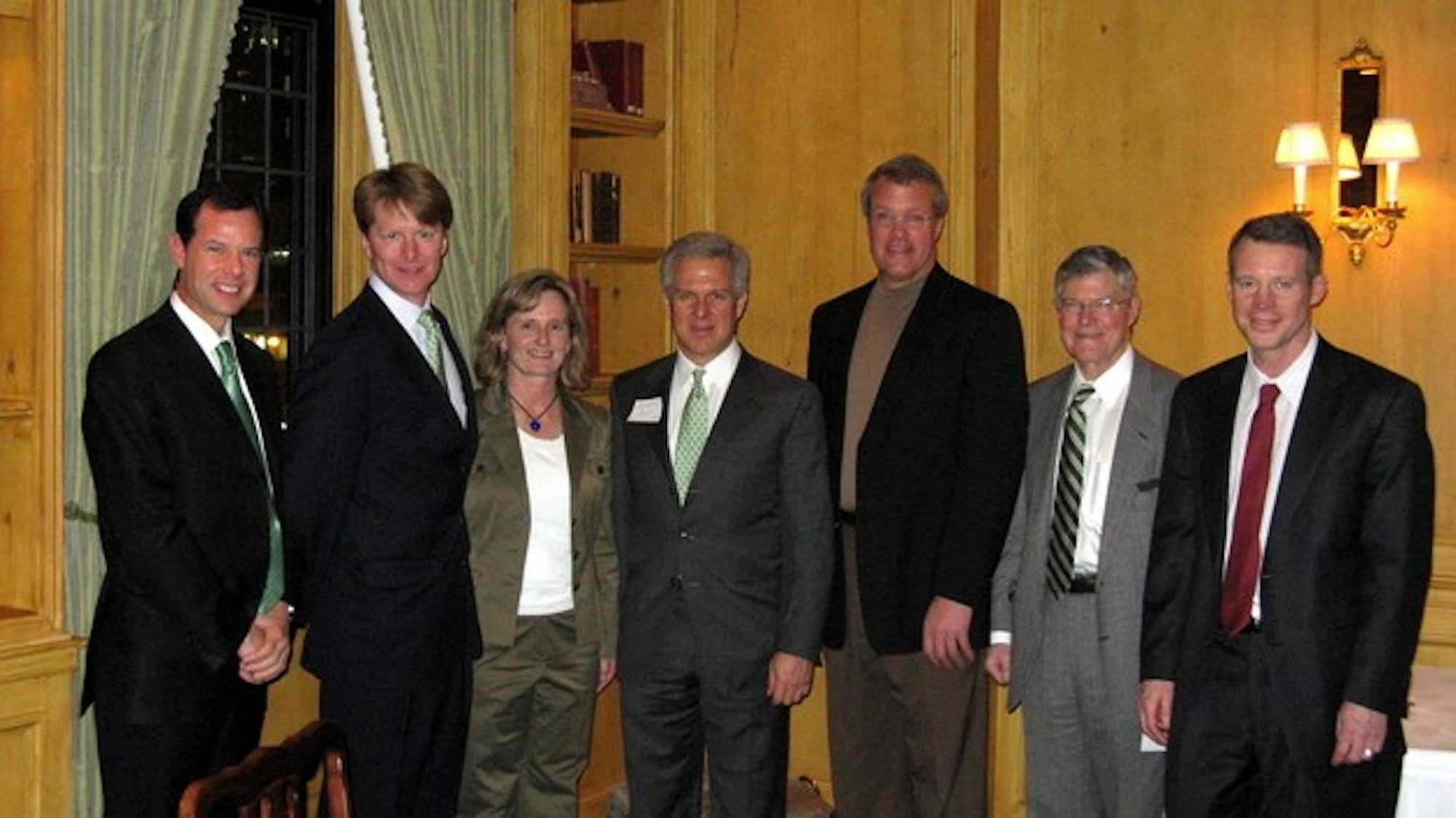 Trustee candidates John Replogle '88, second from left, Joe Asch '79, center, and Morton Kondracke '60, second from right, stand with alumni at an event held in Minneapolis on Tuesday night. 