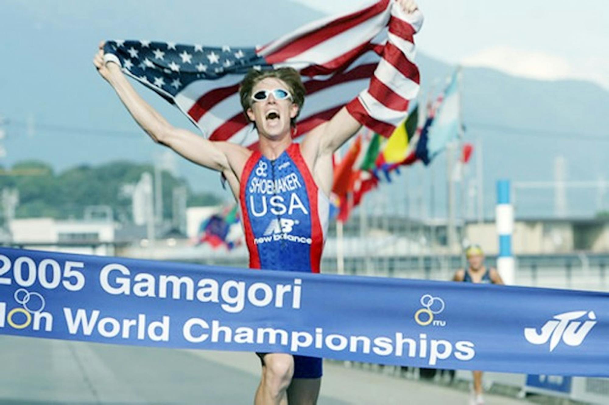 Jarrod Shoemaker '04 crosses the finish line carrying the American flag at the 2005 World Championships.