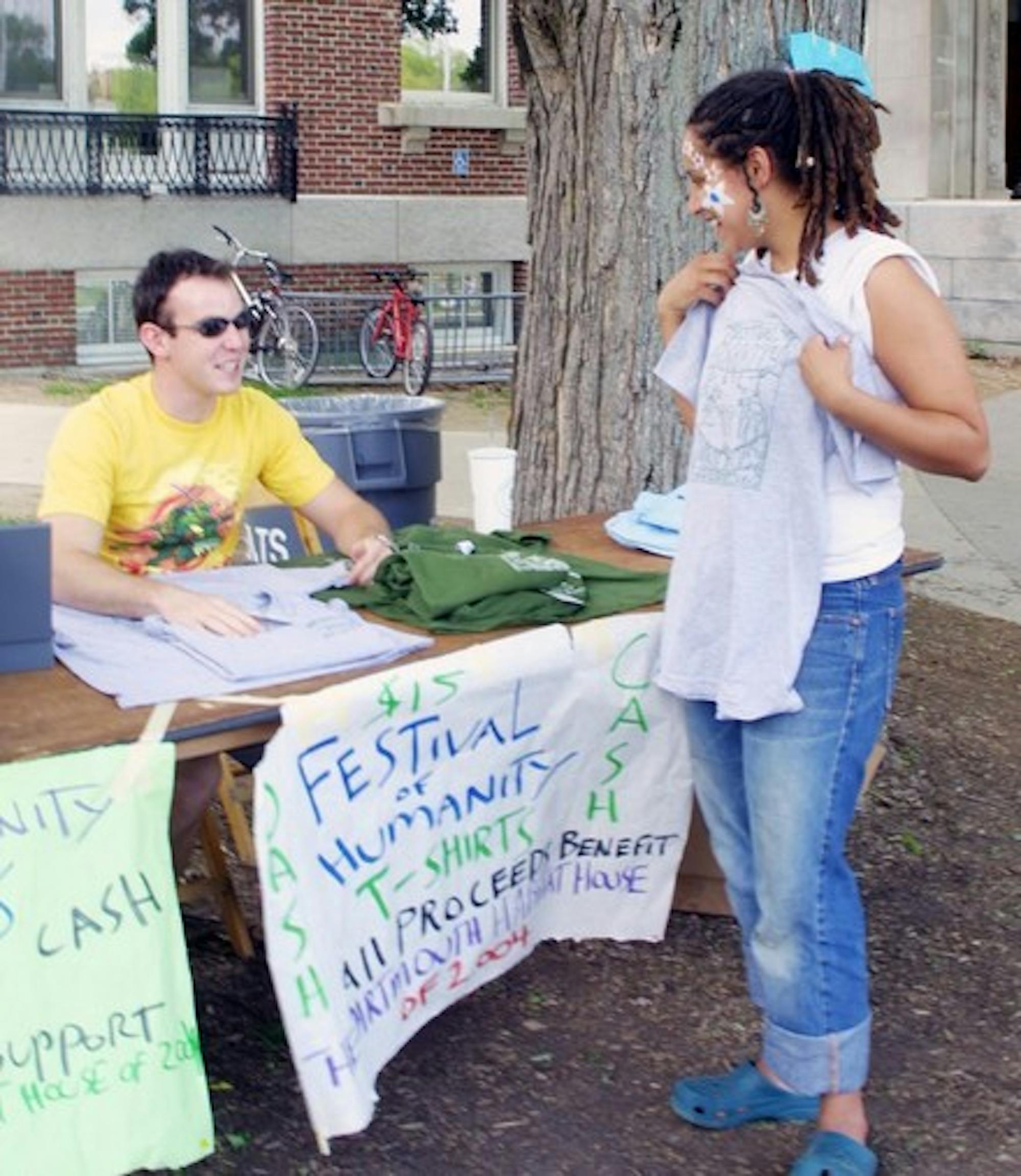 Lane Verlenden '06 sells Festival of Humanity T-shirts during the 2004 Green Key. The Festival plans to fundraise for Habitat for Humanity this year.