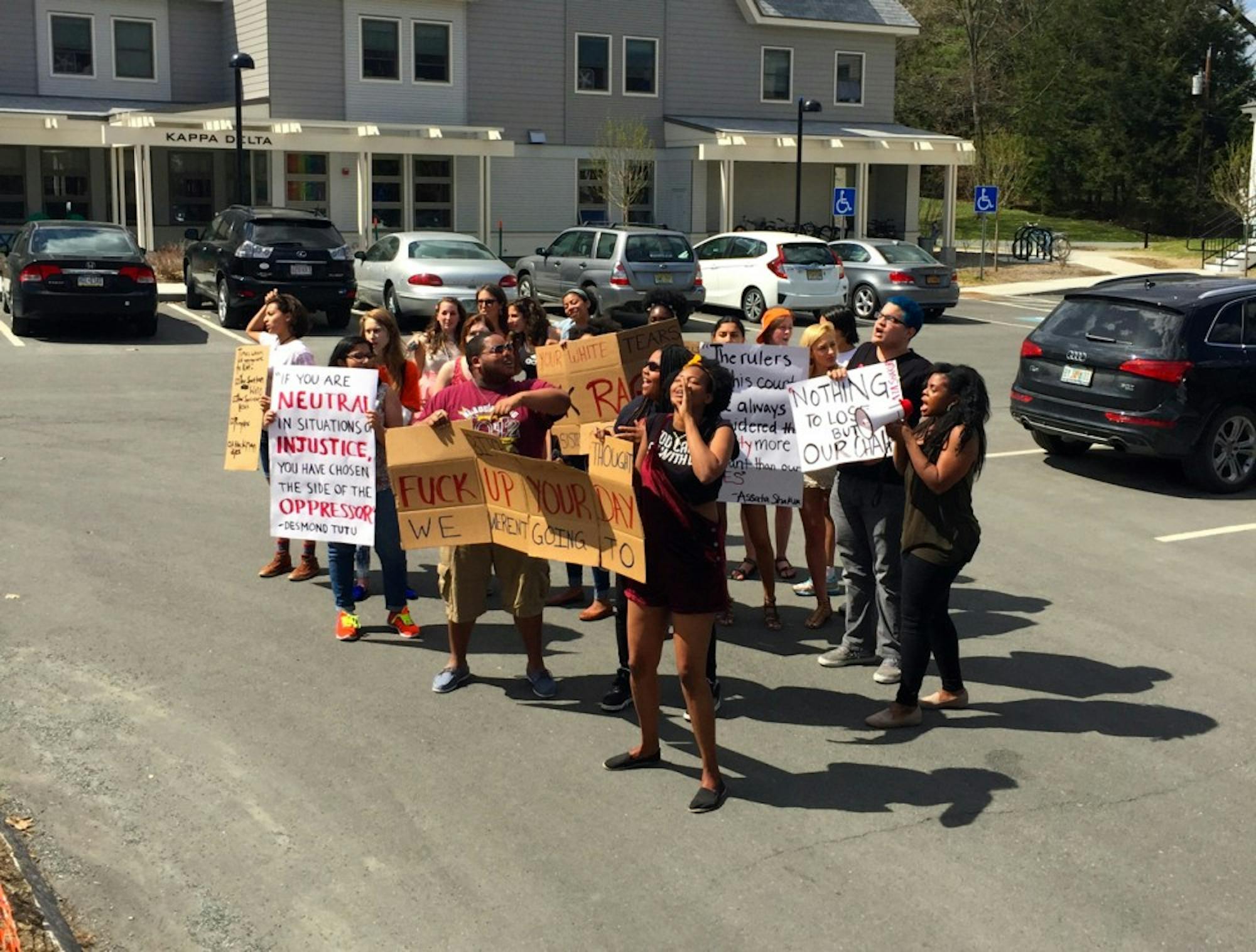 Students protested outside of Alpha Chi Alpha fraternity's Pigstick party.