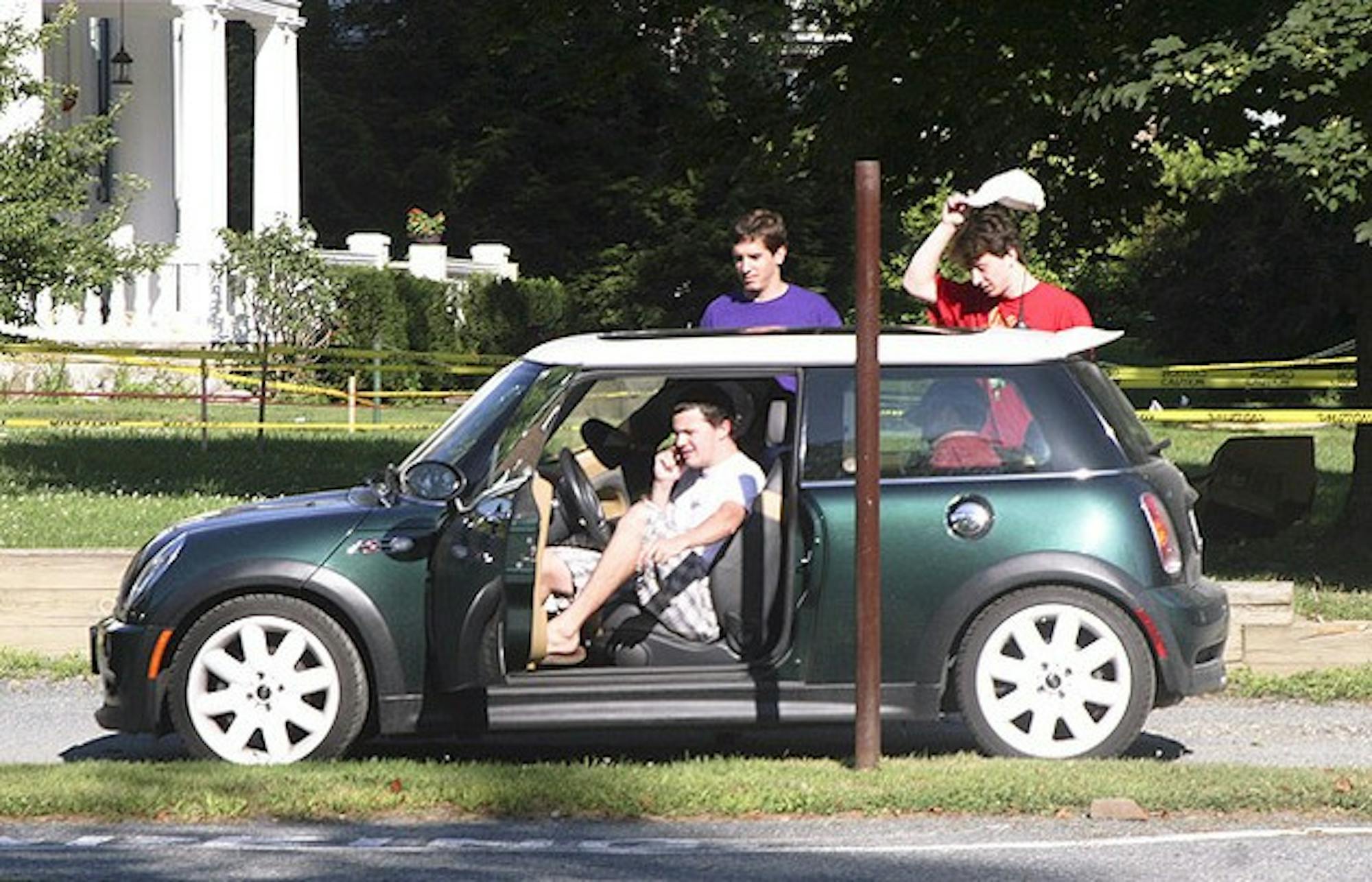 EVERYONE SQUEEZE IN: Five sophomores attempt to pile into a Mini Cooper on Webster Avenue.