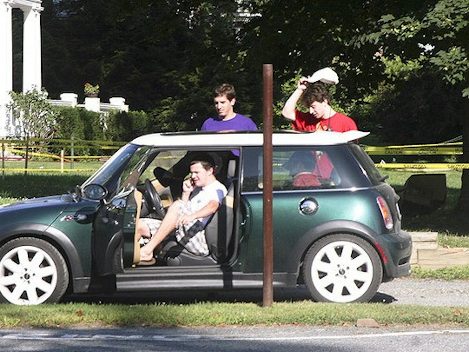 EVERYONE SQUEEZE IN: Five sophomores attempt to pile into a Mini Cooper on Webster Avenue.