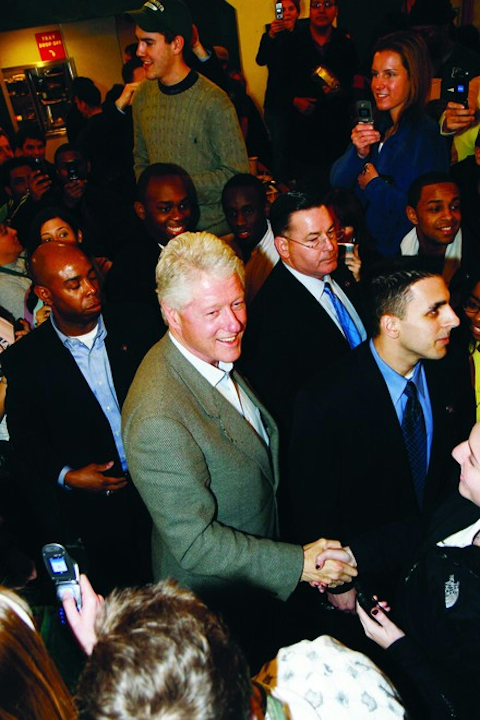 Former President Bill Clinton greets students during an impromptu visit to Food Court following his Monday speech in support of wife Hillary.