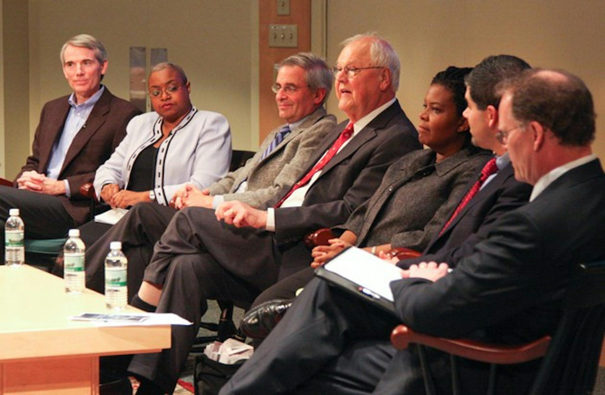 College President James Wright leads a panel of six alumni in a discussion of the climate surrounding the 2008 U.S. presidential elections.