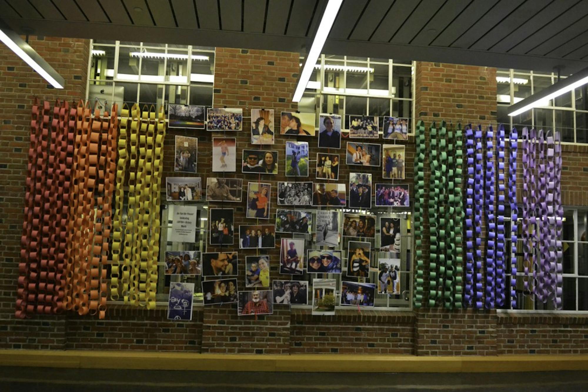 A photo display marks LGBTQ history month in Baker-Berry Library.