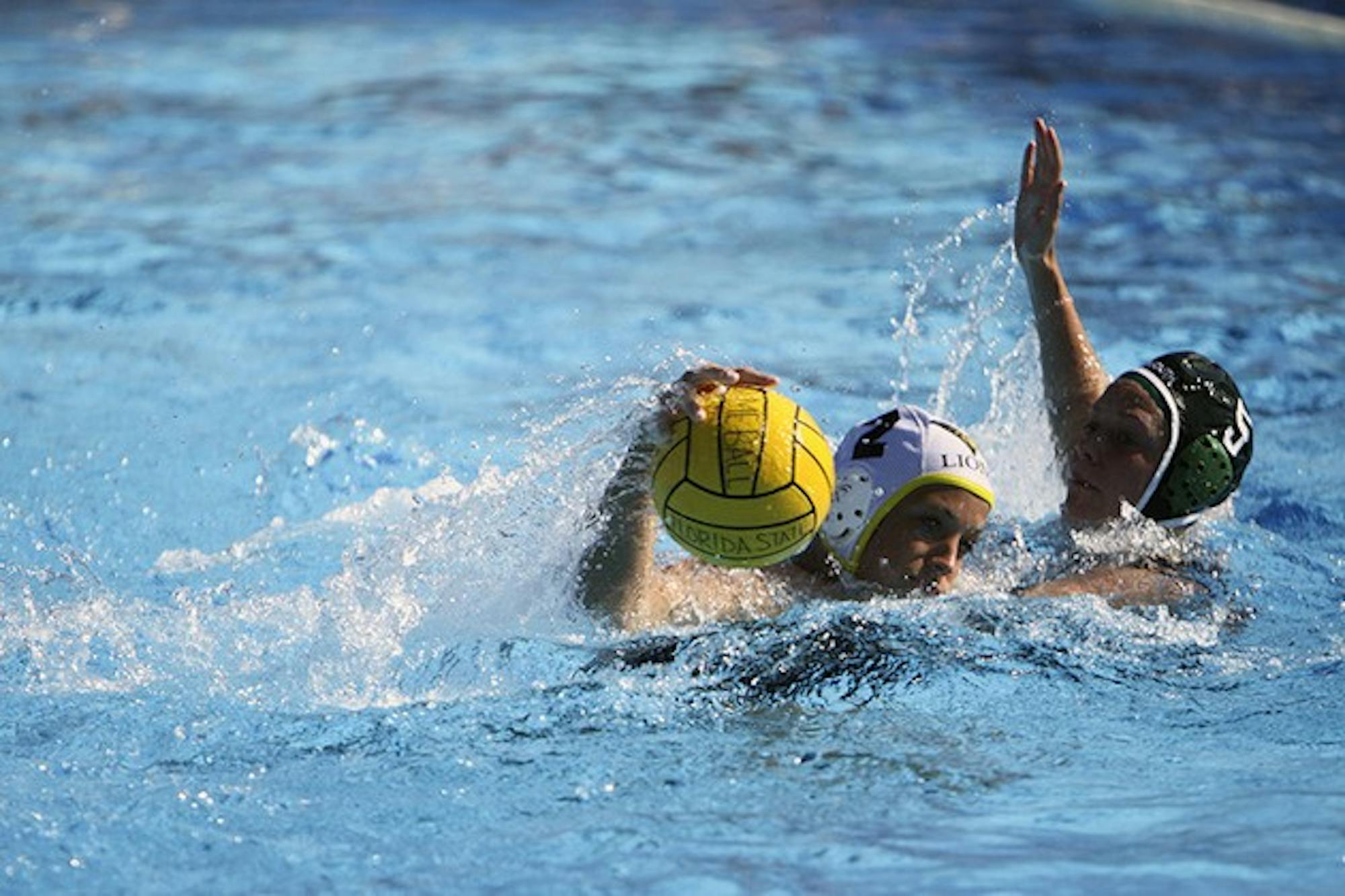 Lisa Rennels '14 defends Lindenwood University's Meghann Kopecky in the women's club water polo's game on Sunday.