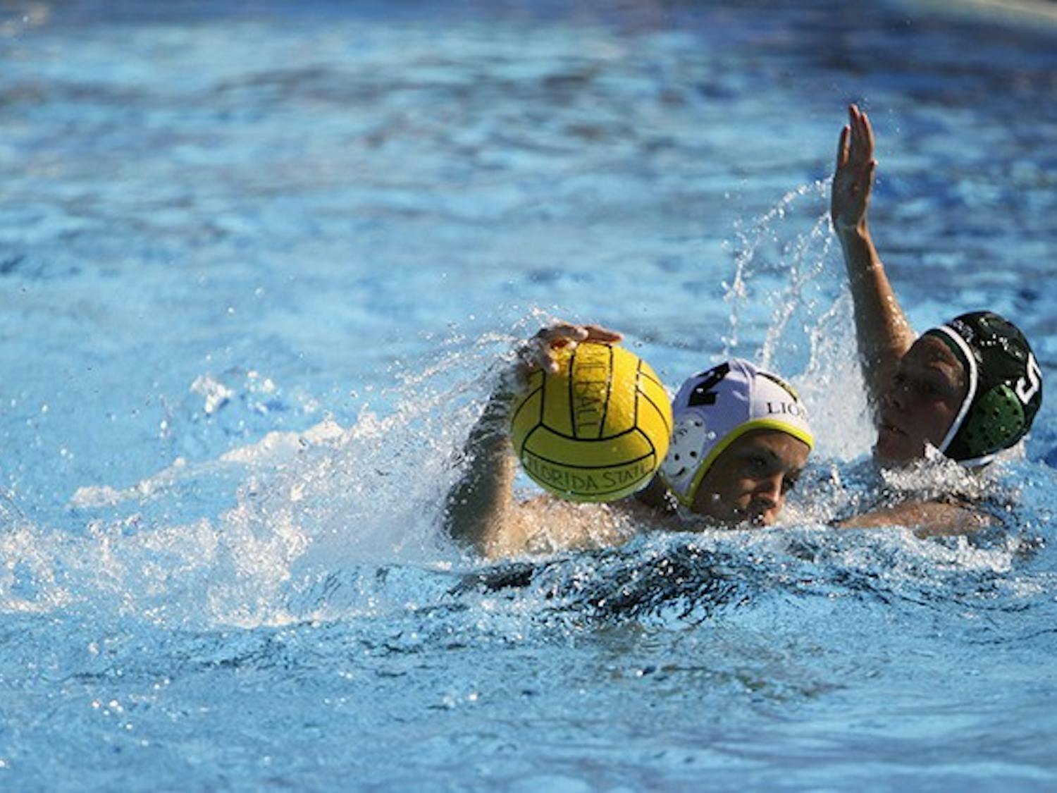 Lisa Rennels '14 defends Lindenwood University's Meghann Kopecky in the women's club water polo's game on Sunday.