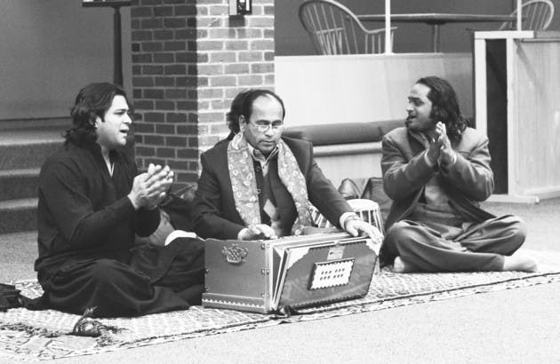 The Qawwali Masters, a musical group from Pakistan, eat dinner with students after a show in Brace Commons.