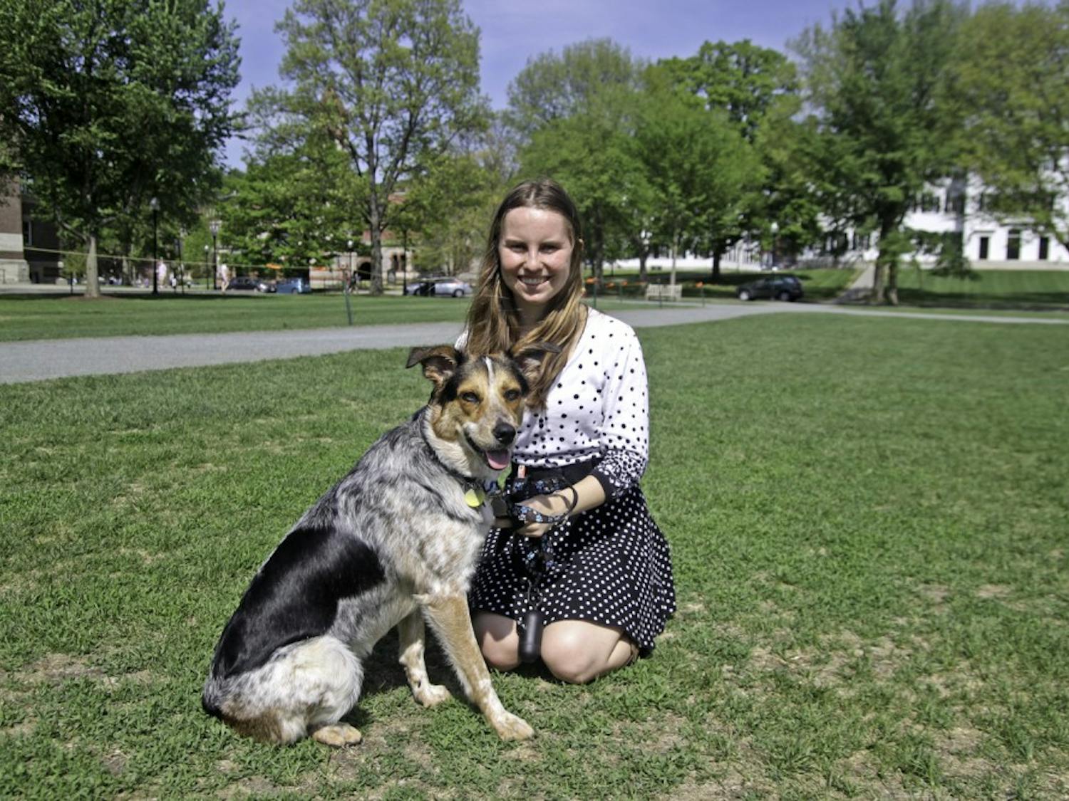 Allie Fudge '18 hangs out with her support dog, Kelsie Iris, on the Green.