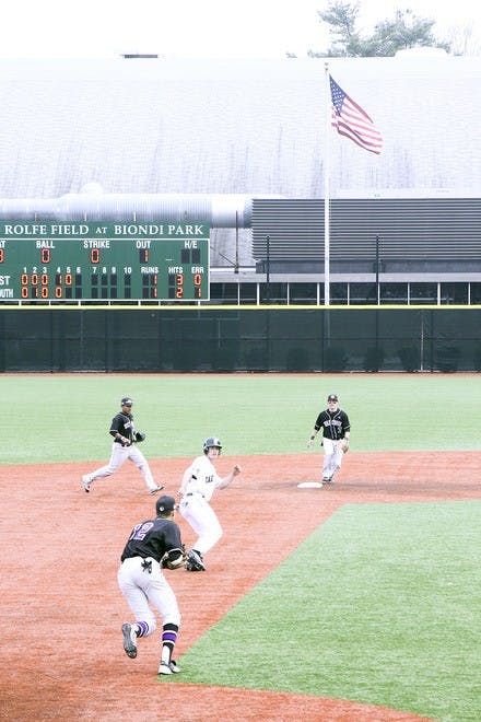 A Dartmouth runner tries to avoid being tagged between second and third base in the Big Green's 4-2 victory over Holy Cross on Wednesday.