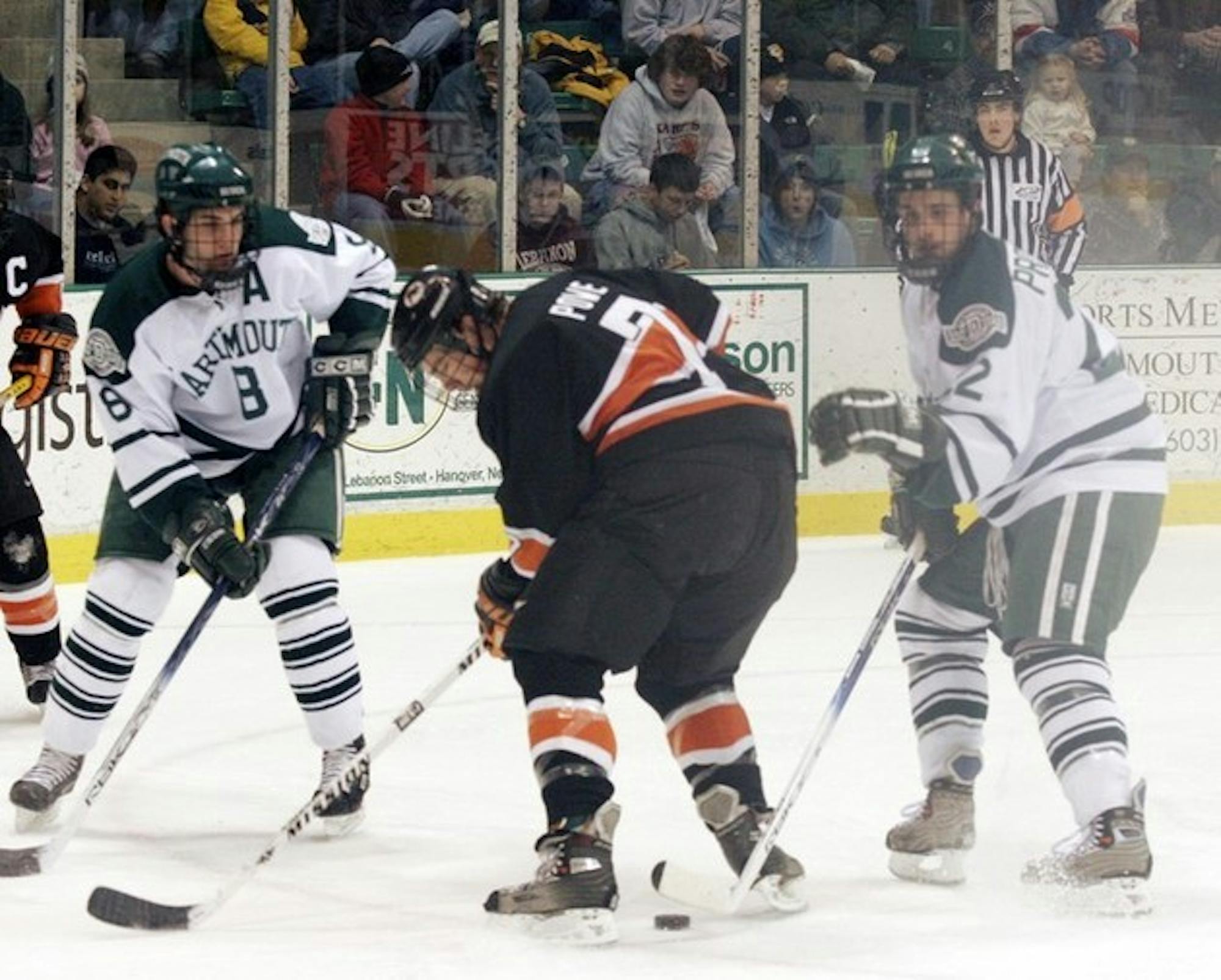 Garret Overlock '06 (pictured left) and Rob Pritchard '09 (right) work together to control a loose puck. The Big Green hopes that next year its freshmen will mesh with the team's veterans as well as they did in 2005-06.